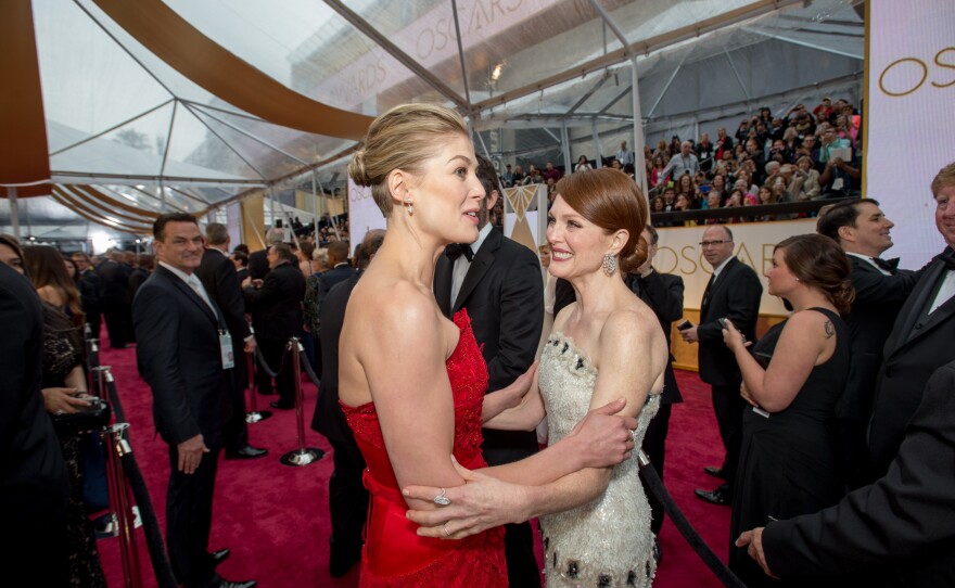 Rosamund Pike (nominated for Best Actress for "Gone Girl") chats with soon-to-be Best Actress winner Julianne Moore (winner for "Still Alice") at the 87th annual Academy Awards, Feb. 22, 2015.