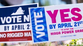 Signs are seen during the Virginia redistricting referendum on April 21 in Fairfax, Va.