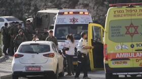 Israeli soldiers and emergency personnel gather near ambulances following a shooting attack near Yehuda Junction, near Hebron, in the occupied West Bank, Friday, Oct. 23, 2026.