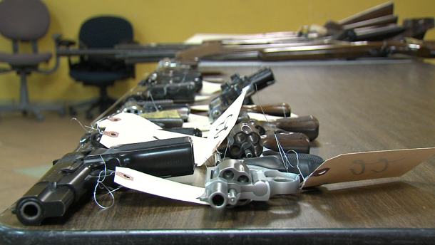 Guns sit on a table after being turned in to San Diego police at a gun buyback event on December 21, 2012 at the United African American Ministerial Action Council in San Diego.