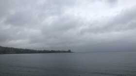 Storm clouds hover over the ocean just south of the Scripps Institution of Oceanography Pier on March 20, 2020.