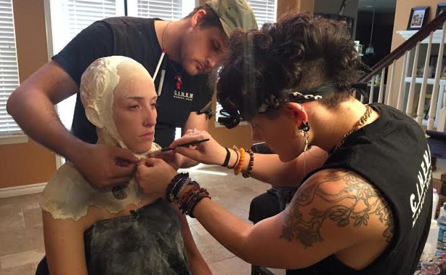 Madison Burger applies makeup to Katie Kotulak at Comic-Con International, July 20, 2016.