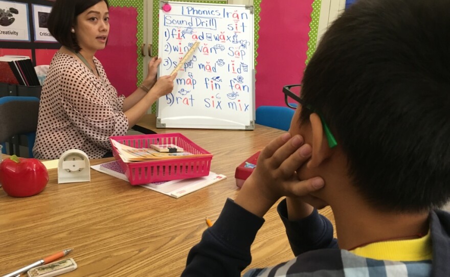 San Gabriel teacher Jenny Tan helps a student who's been in the U.S. less than a year learn the basics of English.