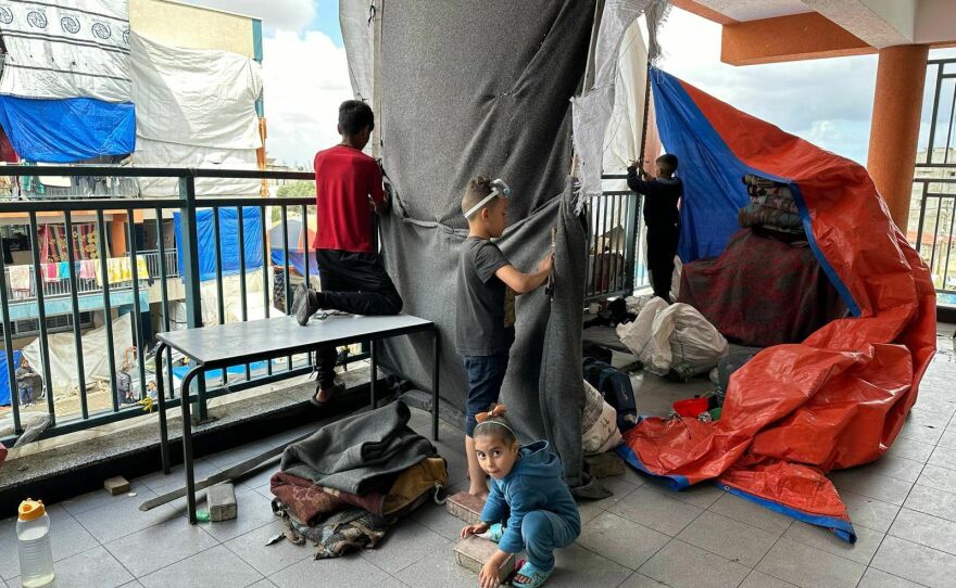 Children are seen piling onto the back of a pickup truck in Rafah as families evacuate the area. But most are leaving by foot, carrying with them whatever they can and dragging luggage with them, following Israeli evacuation orders ahead of an expected assault.