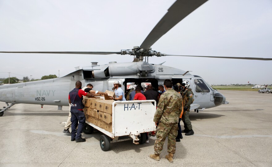 A U.S. Navy helicopter unit, USAID and other support groups prepare to deliver humanitarian aid to remote Haitian towns which were affected by the 7.2 magnitude earthquake, at the Toussaint Louverture International Airport, in Port-Au-Prince on Wednesday.