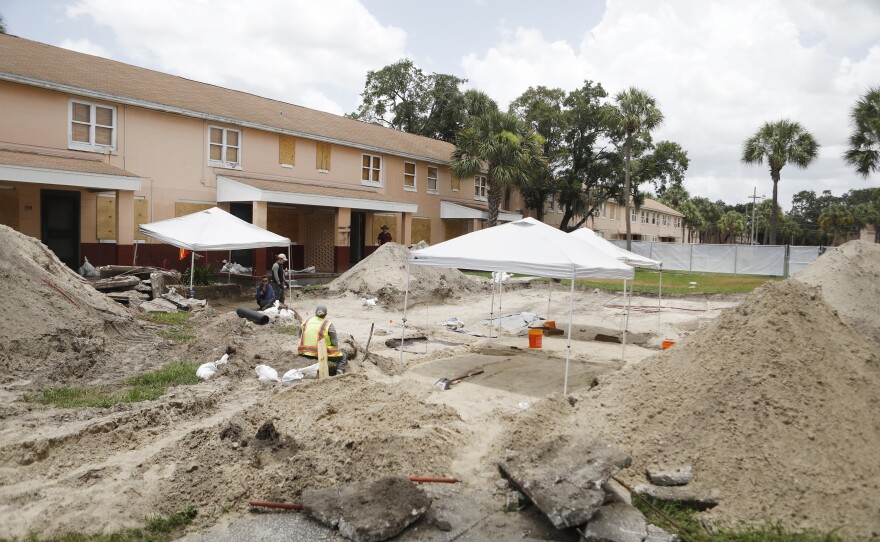 Archaeologists work to uncover graves at the former site of the Zion cemetery found underneath the Robles Park Village housing complex in Tampa, Fla. Another unmarked African-American cemetery with hundreds of graves has been found at the site of a downtown office building in Clearwater, Fla.