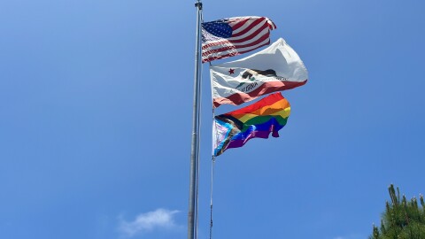 The Pride Progress flag flies underneath the American and California flags, Wednesday, at the Brucker Administration building, San Diego, Calif., May 29, 2024