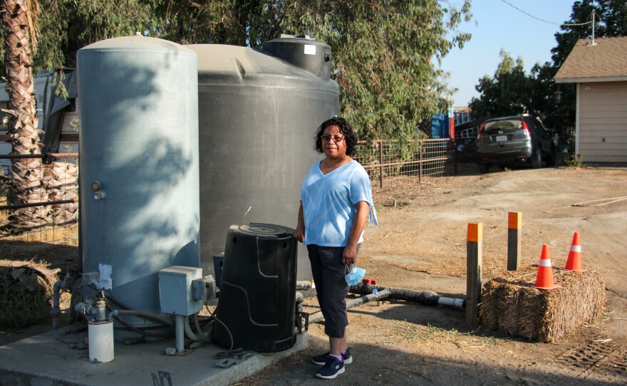 The well at Esther Espinoza's house in Riverdale, Calif., ran dry. A local nonprofit organization delivered a tank and fills it with water, but Espinoza worries that it's not a reliable water supply.