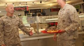 Master Sgt. Ricardo Rivera, a food service technician at Gonzales Hall and a Rio Piedras, Puerto Rico, native, speaks to a Marine about the ice sculpture during the Best of the West competition.
