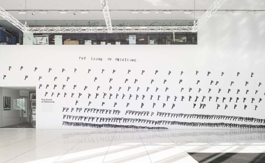 <em>The Sound of Obsessing </em>is a 2020 large vinyl print filled with hand-drawn "P"s by Christine Sun Kim. "When people obsess over something, they return to it over and over again in their mind," Kim writes. "There's a rhythm to it. As time goes on, the obsession quickens, represented by the shrinking distance of p's. Finally, at the end, the p's are crowded and your mind is racing non-stop."