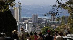 A crowd of people watch Oahu's southern shore in anticipation of a possible tsunami along Tantalus Drive in Honolulu, Hawaii on February 27, 2010 in Honolulu, Hawaii. 