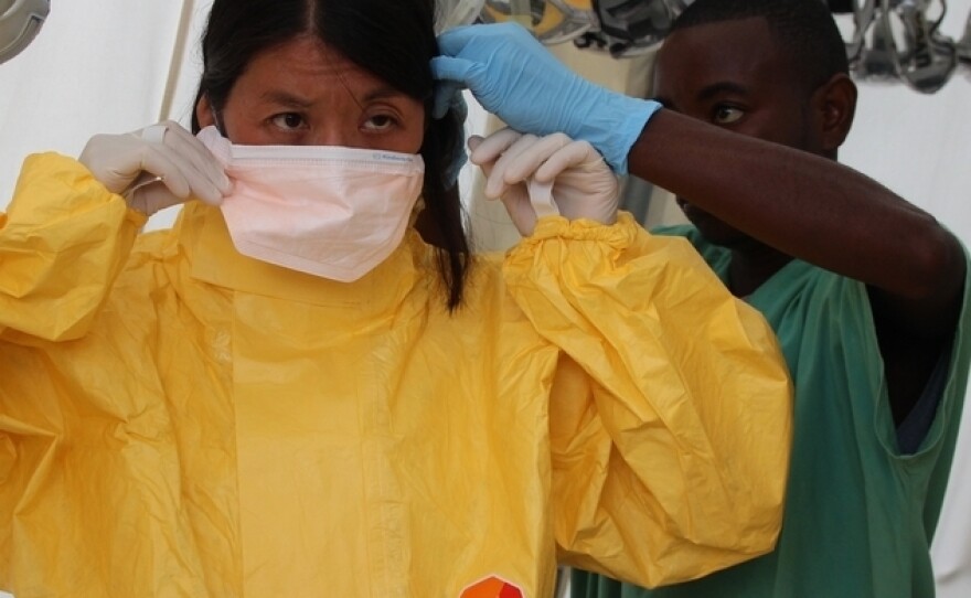 Joanne Liu, MSF International President, gets suited up at an Ebola treatment center in Kailahun, Sierra Leone.