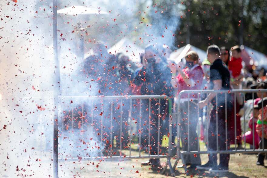 San Diego Mayor and Councilmembers Chris Cate and Marni von Wilpert dodging firecrackers lighting up at the San Diego Tet Festival in Mira Mesa Community Park, Feb. 5, 2022.