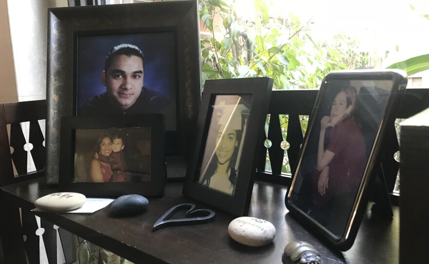 An portrait of Tariq Khamisa (far left) sits on a table in the living room of his father's La Jolla home, Nov. 26, 2018.