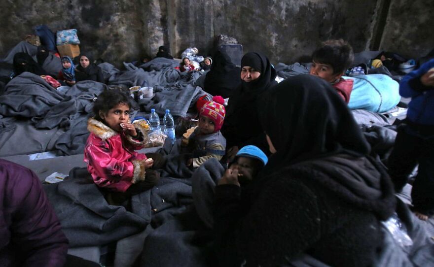 Syrians who fled rebel-held areas of Aleppo take shelter Wednesday in the nearby town of Jibrin.