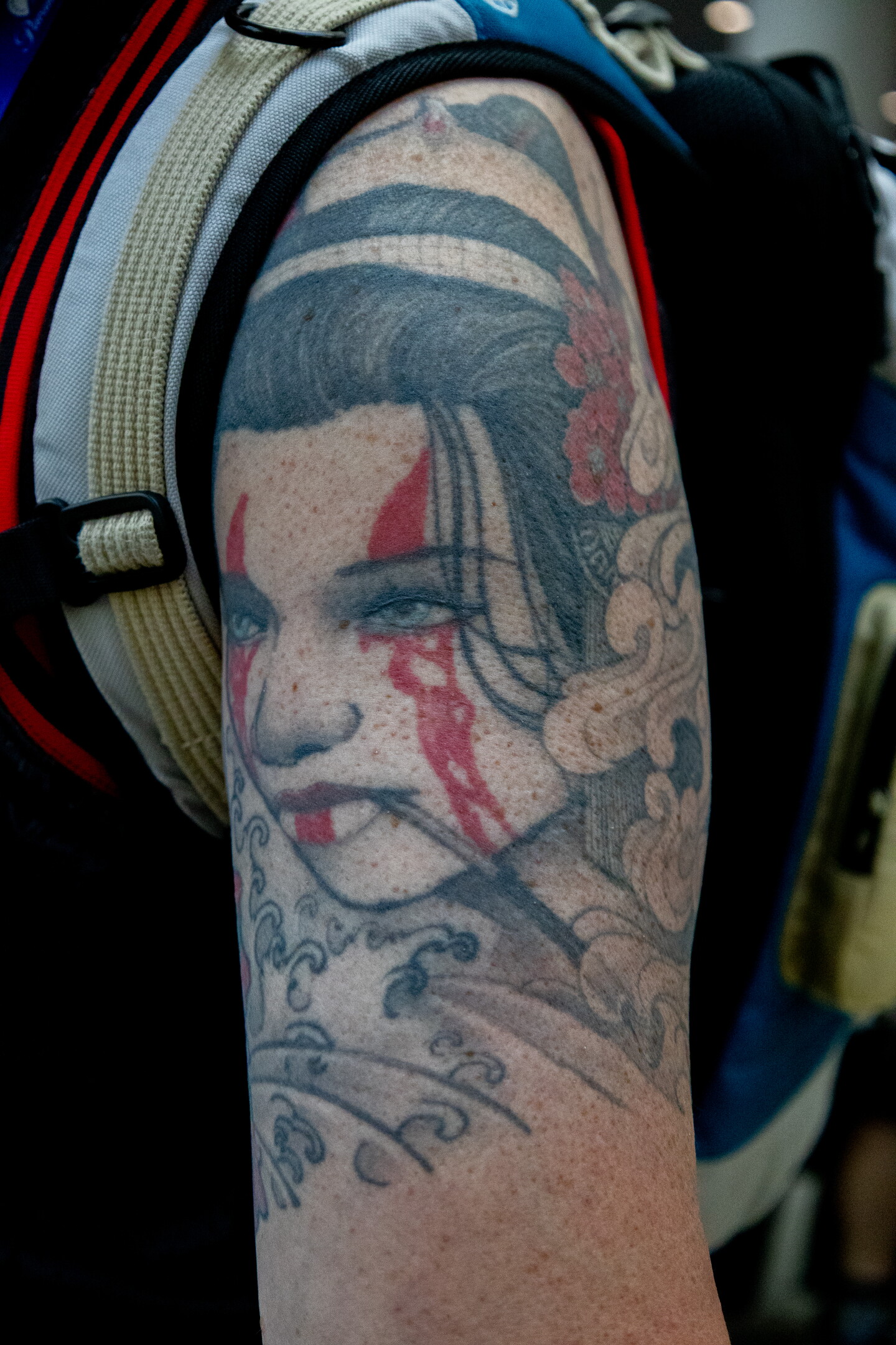 A geisha smokes a pipe in this intricately detailed tattoo at Comic-Con, July 23, 2026.