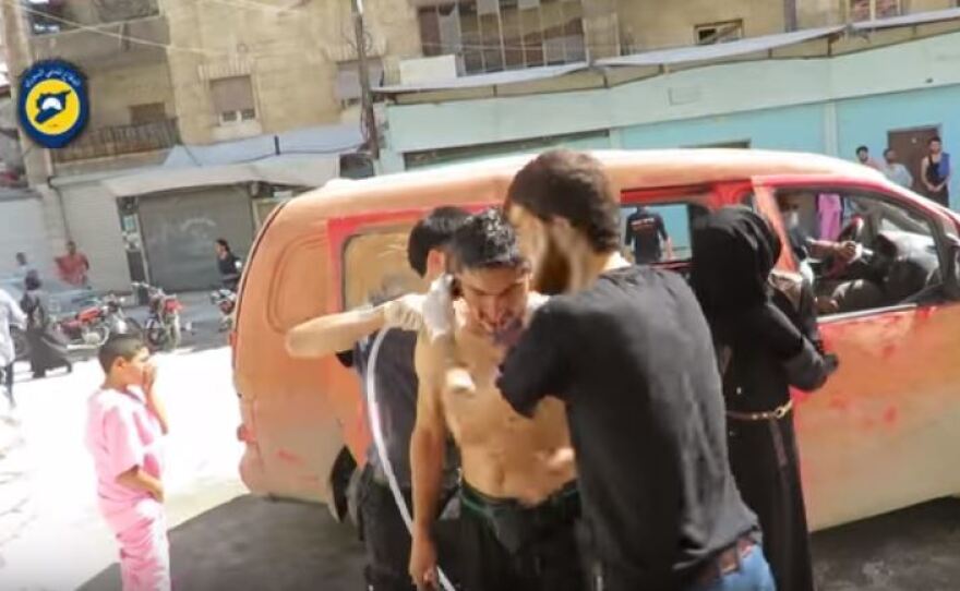 A video released by the White Helmets, a team of volunteer rescue workers, shows men hosing down civilians after the reported chlorine gas attack Tuesday in Aleppo, Syria.