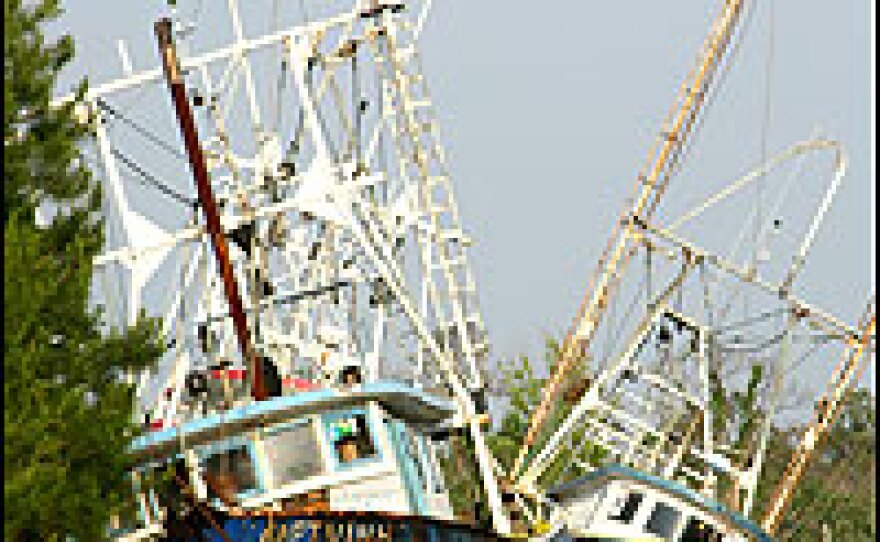 Two of the two dozen boats still stranded inland after Hurricane Katrina hit Bayou le Batre.
