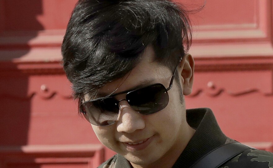 Vorayuth "Boss" Yoovidhya, whose grandfather co-founded energy drink company Red Bull, walks to get in a car as he leaves a house in London, in April 2017. Charges have been dropped against the Thai heir to the Red Bull energy drink fortune who is accused in a 2012 car crash that killed a Bangkok police officer.