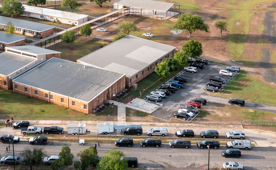 Authorities say the gunman entered Robb Elementary School through a rear door near a parking lot — and they have clarified that a teacher did not leave the door propped open. The school is seen here in an aerial view from May 25, the day after the shooting.