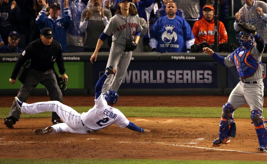 Alcides Escobar of the Royals scores a run on a two-run RBI single hit by Eric Hosmer in the fifth inning of Game Two of the World Series.