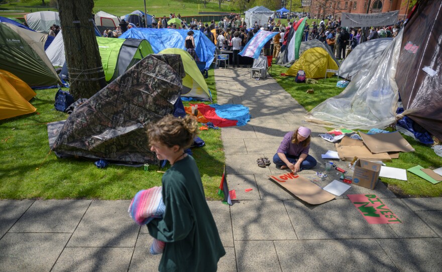 Students create signs at Wesleyan University during a May Day event at their encampment on Wednesday in Middletown, Conn.