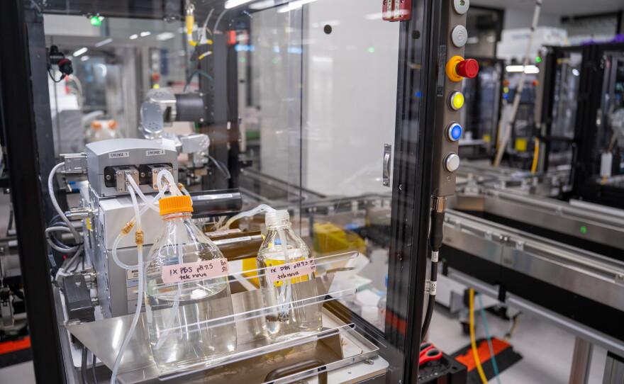 Most of the robots in this lab do not resemble humans, and they perform their work while encased in glass.