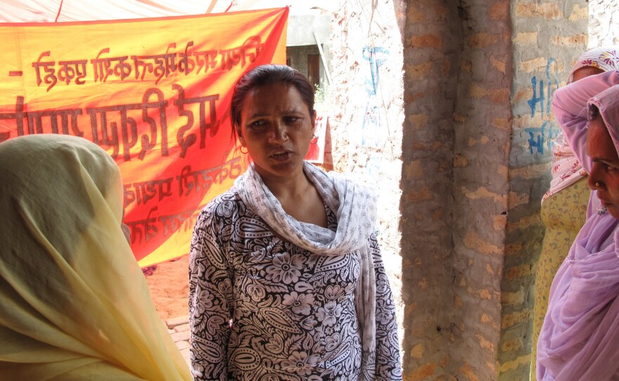 Saroj listens to the complaints and concerns of other women cooks and kitchen help during a union meeting.
