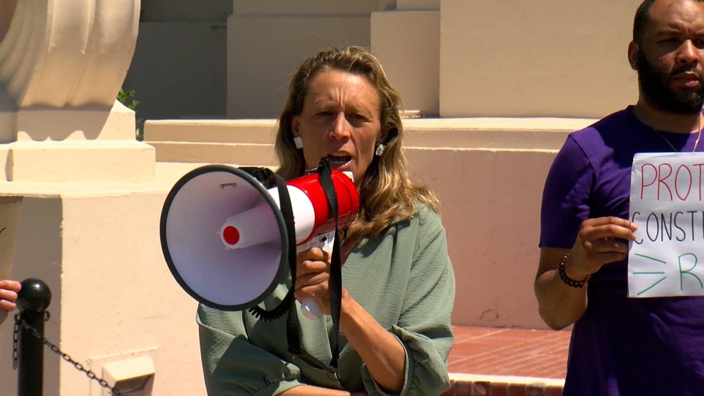 Acting Chair of the San Diego County Board of Supervisors Terra Lawson-Remer is shown speaking through a bullhorn at the San Diego County Administration Building on April 8, 2025.