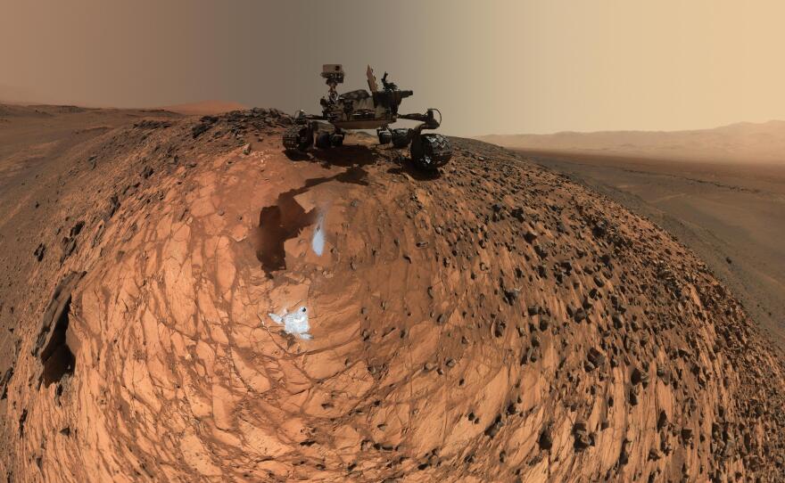 After it drilled two holes in the "Buckskin" rock on Mars, the Curiosity rover took a series of photos that were turned into this panoramic self-portrait. The rover is sitting on the crest of a 20-foot hill.