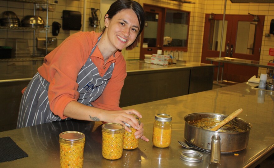 Maritza Arellano, a dietetic intern at Montana State University, works with the Buffalo Nations Food Systems Initiative to can hot sauce made from produce from an Indigenous garden in Bozeman, Mont.