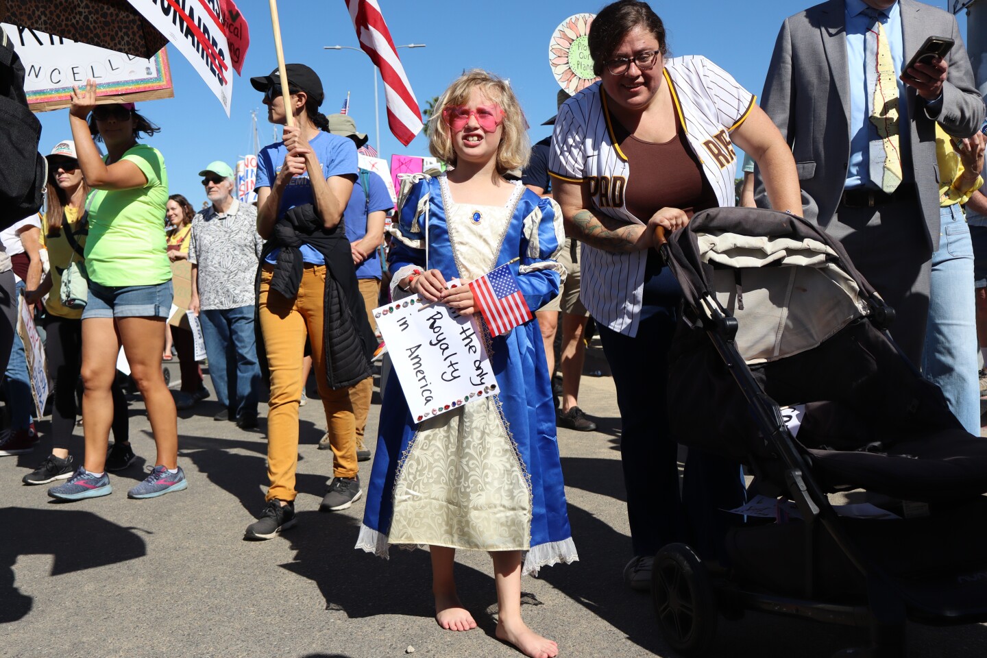 Adele Flowers, 8, holds a sign that reads "I'm the only royalty in America" during a "No Kings" march in San Diego on Saturday, Oct. 18, 2025.