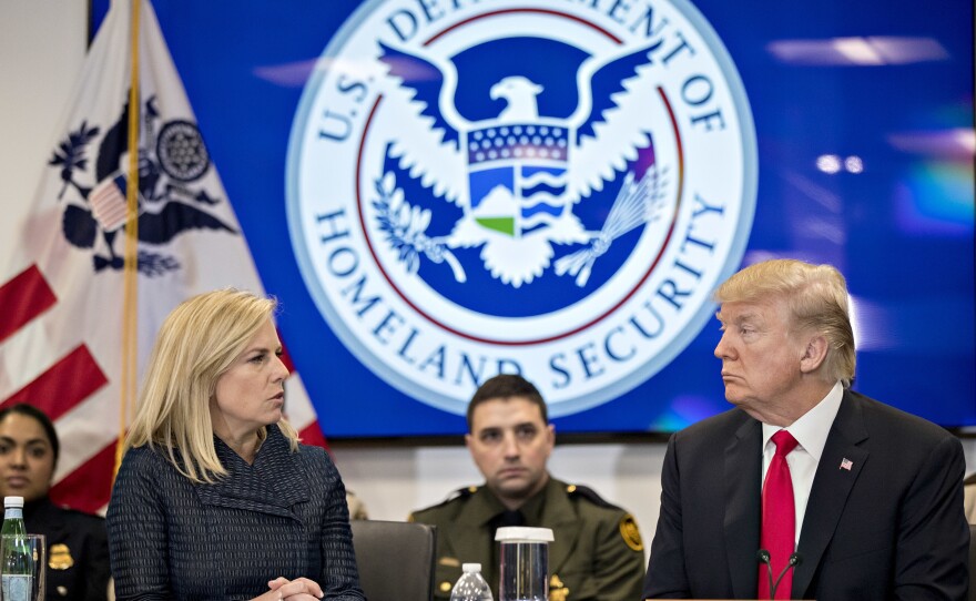 Then-President Donald Trump and the Homeland Security secretary at the time, Kirstjen Nielsen, speak during a Customs and Border Protection roundtable in Virginia in 2018. The Biden administration rescinded an agreement from that time between the Homeland Security and Health and Human Services departments that it says hampered efforts to find safe homes for unaccompanied minors.