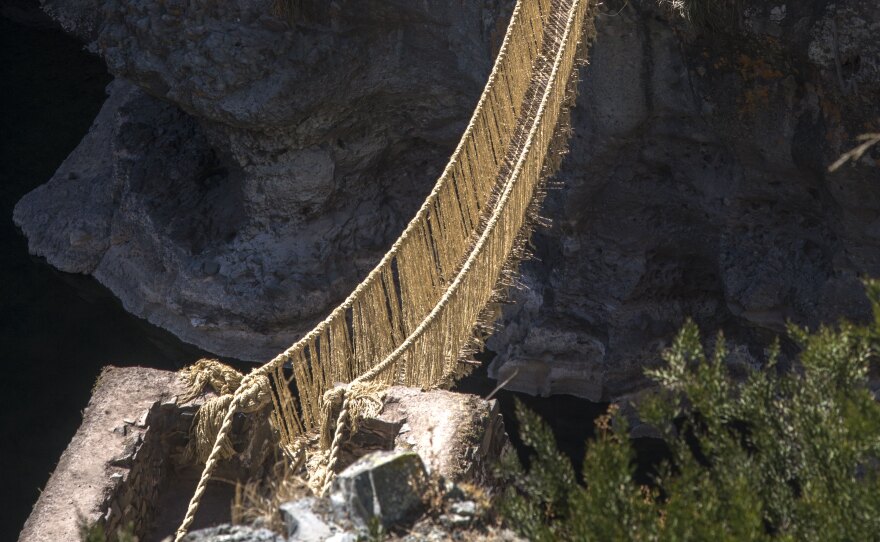 A suspension bridge made of twisted plant fibers stretches high above the Apurimac River in Peru. Local residents, descendants of the Inca, have been making bridges like this for some 500 years.