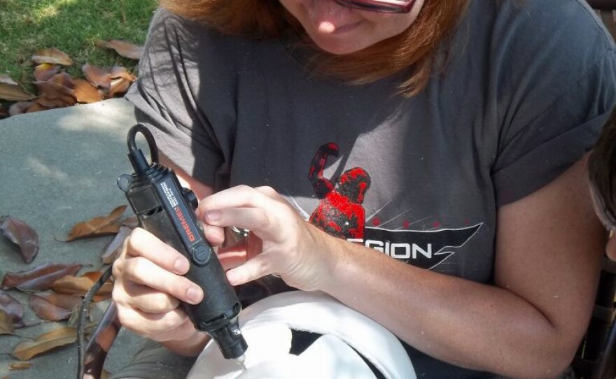 Garrison member Ingrid Moon works on a Clone Trooper helmet at an armor party. Moon is also executive officer of the First Imperial Stormtrooper Detachment.