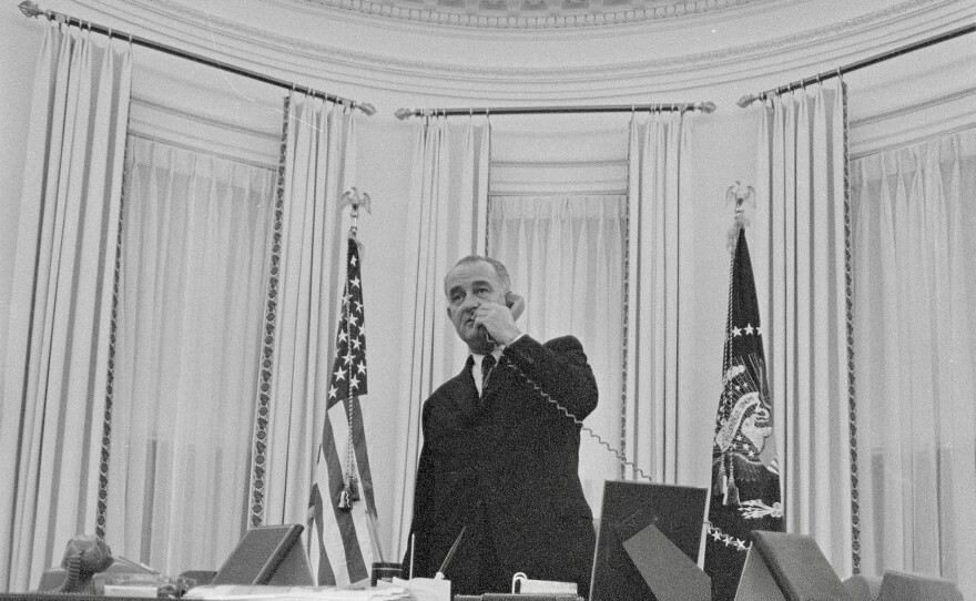 President Lyndon B. Johnson standing in the Oval Office on a phone call days after becoming president in 1963.