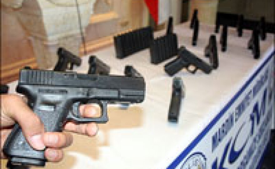 Police in the Turkish border town of Mardin display 18 Glock handguns that were captured from smugglers near Turkey's border with Iraq and Syria. The police chief says the pistols are American-issued, distributed to Iraqi security forces and then sold to arms dealers in northern Iraq.