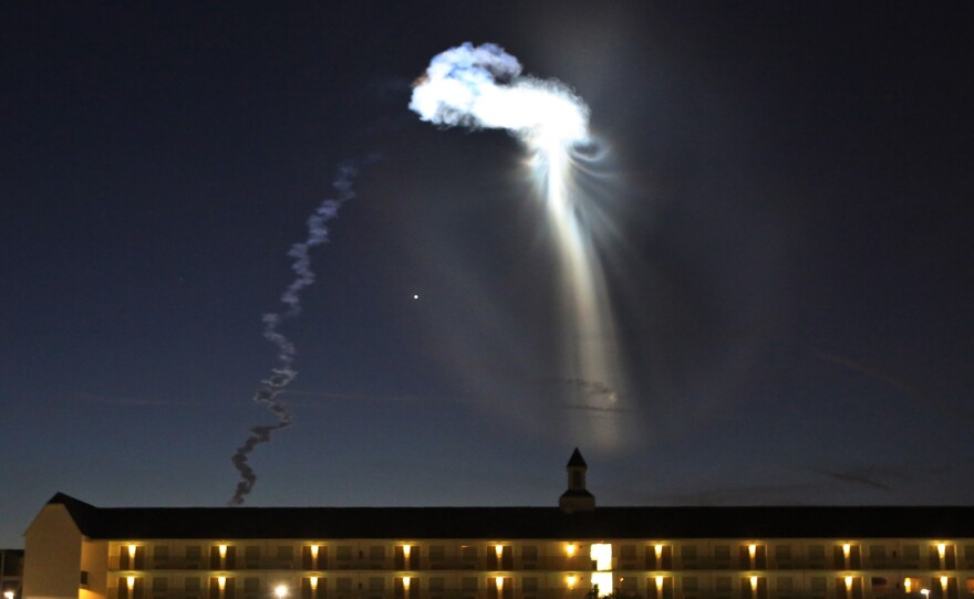 A view from west Orlando shows an Atlas V rocket flying into sunlight, creating a unique light show last month in Orlando, Fla.