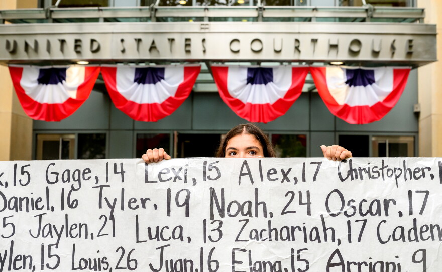 Olivia Konar holds a banner with names of young people who advocates say died as a result of social media outside the Ronald V. Dellums Federal Building and U.S. Courthouse on Tuesday, Aug. 18, 2026, in Oakland, Calif. Her sister Coco Konar died in 2022 when she was 17. Social media company Meta agreed to a nearly $17 billion settlement with a group of states over its child safety practices.