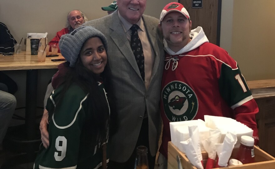 Analise with their brother and Tom Reid, a former hockey player.