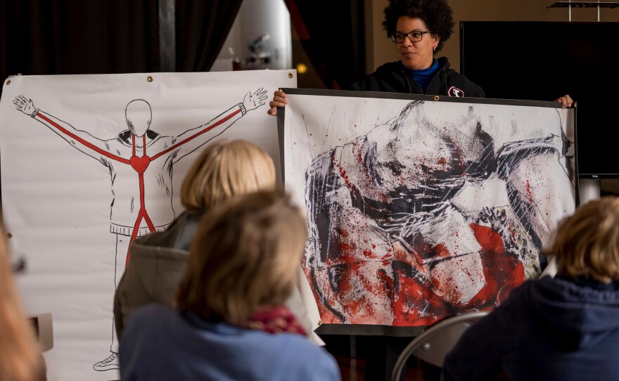Participants listen to Dr. Laurie Punch, a trauma surgeon at Barnes-Jewish Hospital in St. Louis, as she teaches a "Stop the Bleed" class in November in St. Louis. Attendees learn far more than how to staunch a hemorrhage, Punch says. They also start to identify as helpers.