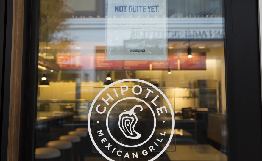 A sign saying "we hope to be opening soon" is pictured outside a new Chipotle Mexican Grill location at University Village in Seattle in November.