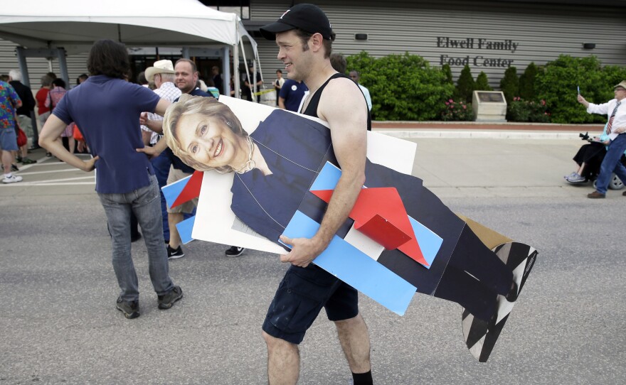 A man carries a cardboard cutout of Hillary Clinton in Des Moines, Iowa. Clinton and other traditional candidates have struggled to breakthrough as outsiders have captured the attention this summer.