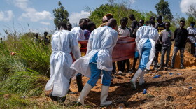 Health workers carry the coffin of a person suspected of having died from Ebola in the Democratic Republic on Congo.