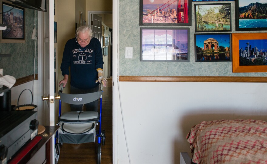 Campbell is able to move around his house with the help of a walker.