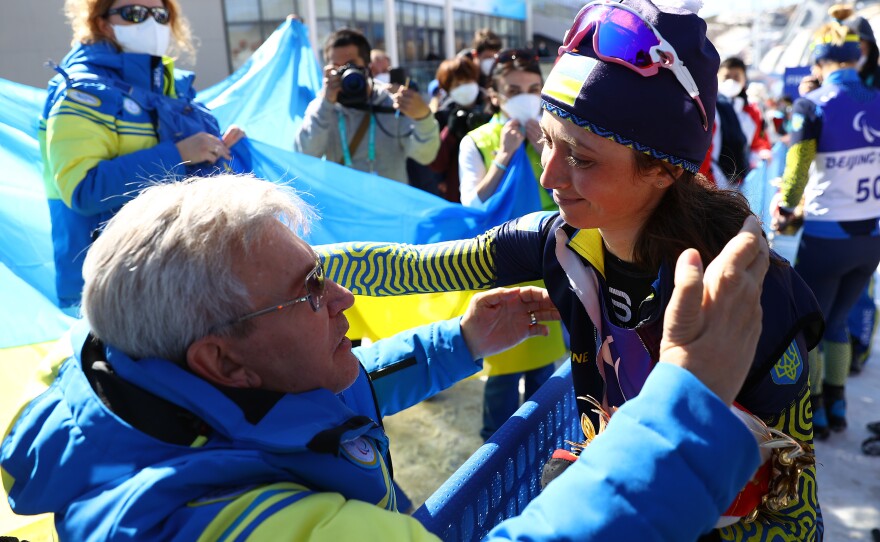Gold medalist Iryna Bui of Team Ukraine celebrates with Valerii Sushkevych, the president of Ukraine's Paralympic committee, on Tuesday.