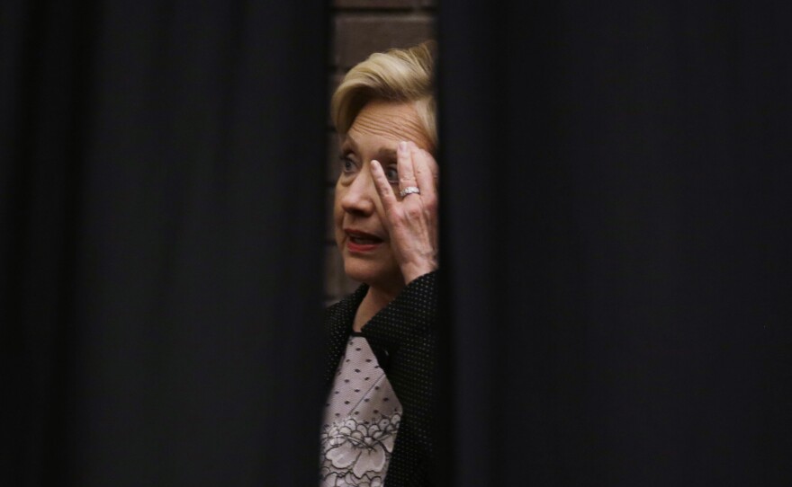 Hillary Clinton waits behind a curtain before a rally at the University of Wisconsin-Milwaukee Thursday. She continues to struggle to explain her use of a private email server as secretary of state.