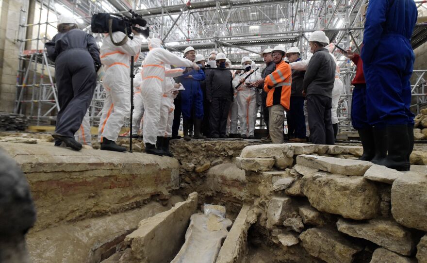 France's Culture Minister Roselyne Bachelot (center left) visits the Notre Dame Cathedral archaeological research site in Paris on March 15 after the discovery of a 14th century lead sarcophagus.