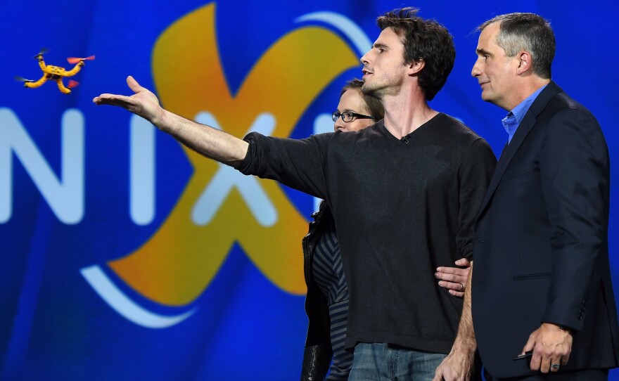 Developers Jelena Jovanovic (from left) and Christoph Kohstall and Intel Corp. CEO Brian Krzanich watch the Nixie wearable drone camera at the International Consumer Electronics Show in Las Vegas.