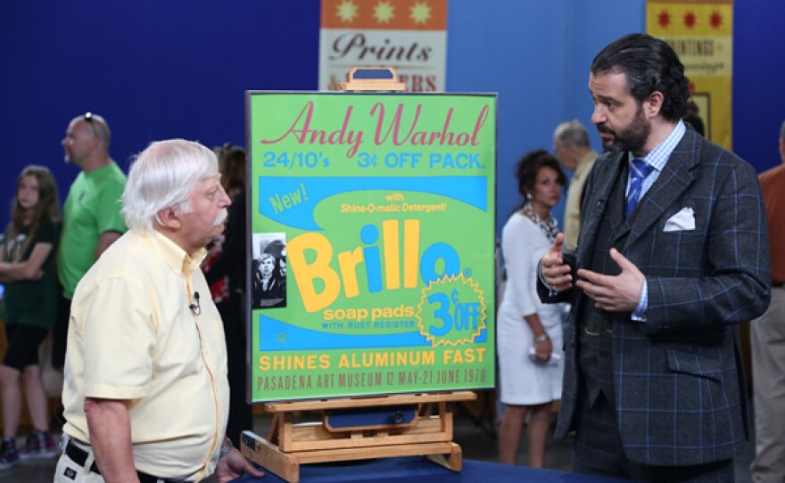 Nicholas Lowry (right) appraises a 1970 Andy Warhol poster for $3,000 to $4,000 in Detroit, Michigan. The owner bought the poster at his campus bookstore for around ten dollars and had it signed by Warhol himself.